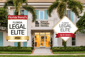 Florida Legal Elite 2022 badges in front of Gould Cooksey Fennell office building